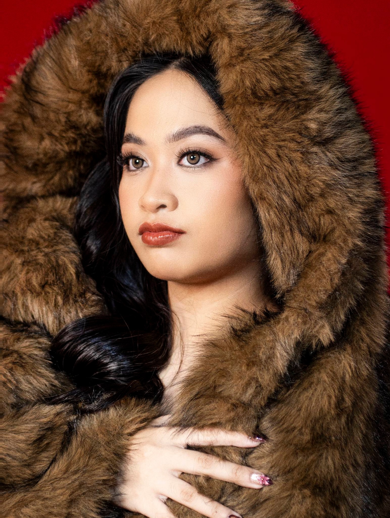 Soft glam portrait on red backdrop