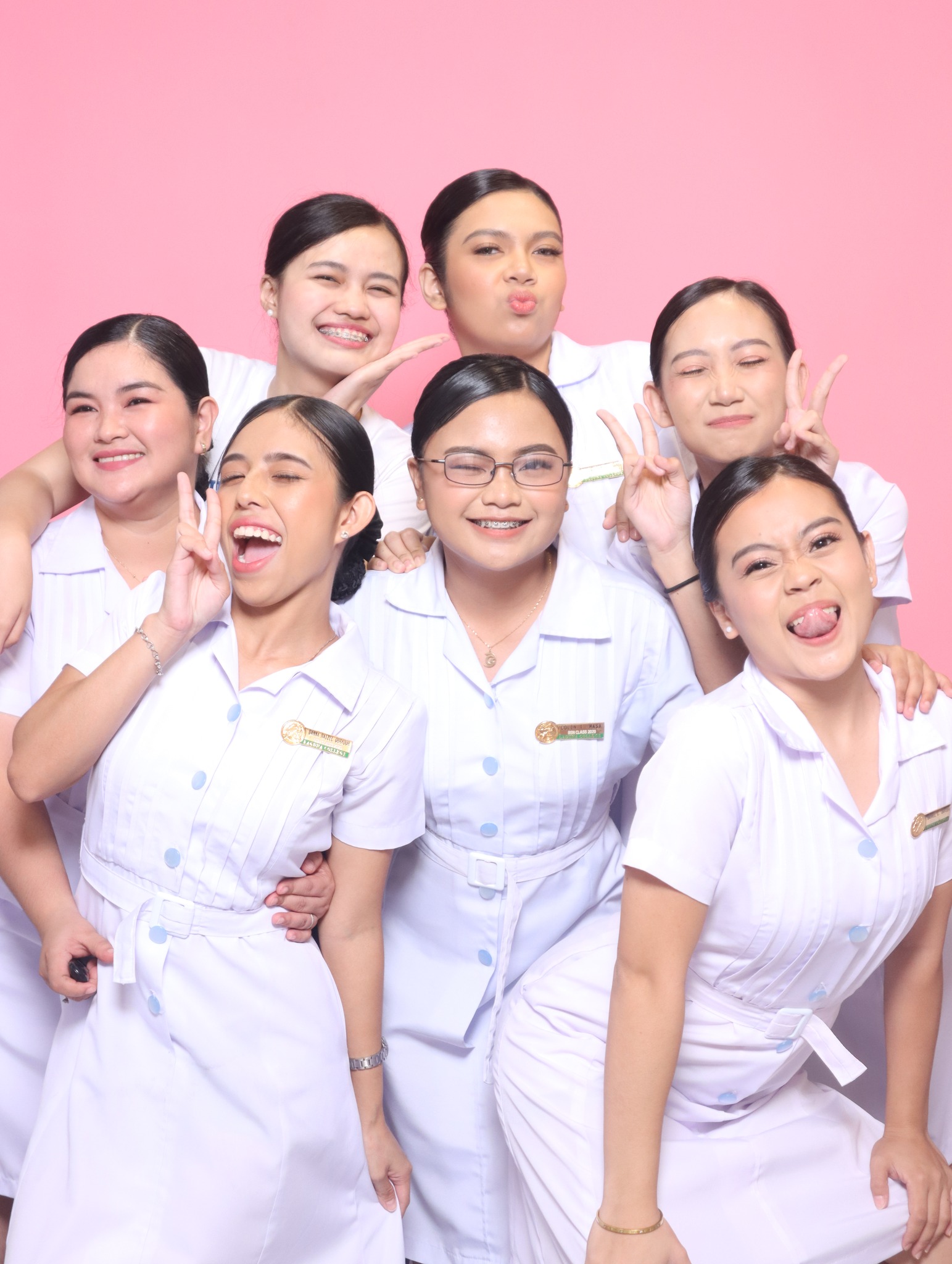 Group portrait against a pink backdrop